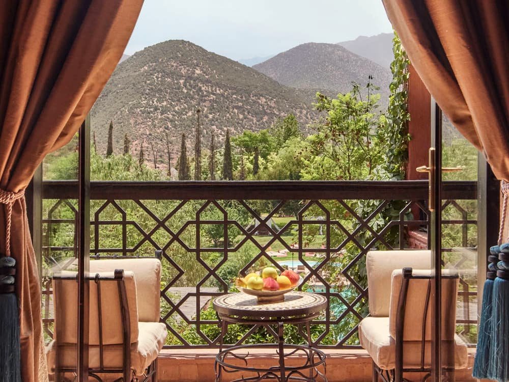 A quiet terrace framed by curtains, looking out to the Atlas Mountains.